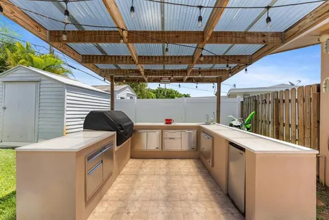 an aerial view of a house with swimming pool garden and outdoor seating