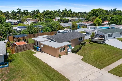 an aerial view of a house with a swimming pool