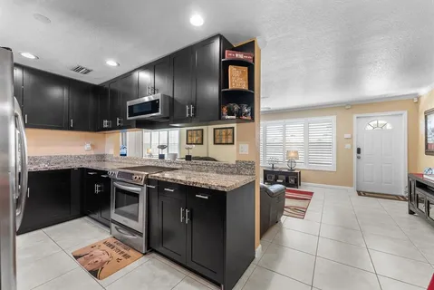 a kitchen with a stove and a refrigerator