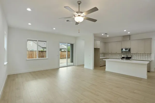 a view of kitchen with sink a microwave and a stove