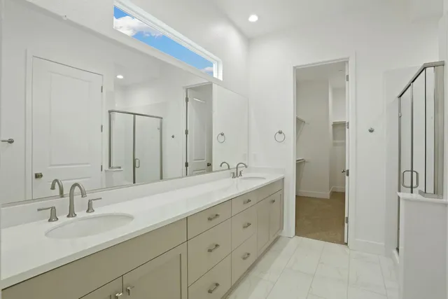 a spacious bathroom with a double vanity sink mirror and double