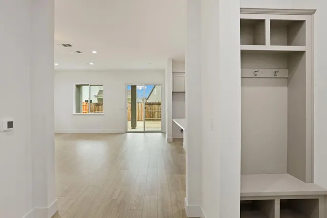 a view of a room with wooden floor and windows