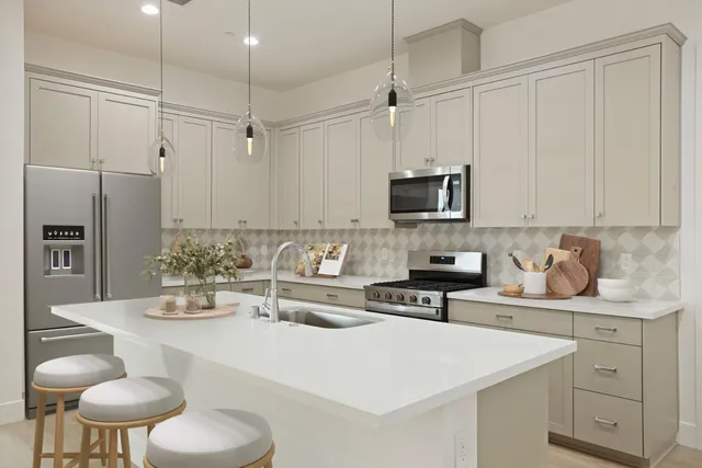 a kitchen with a sink a stove and chairs