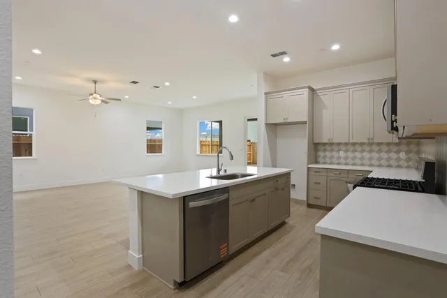 a kitchen with a sink stove and cabinets
