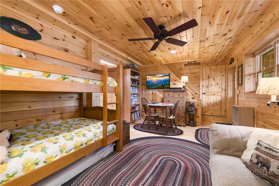 259 Greenbriar Road Beech Mountain, NC 28604 - Photo 27 of 41 a bedroom with furniture and a large window