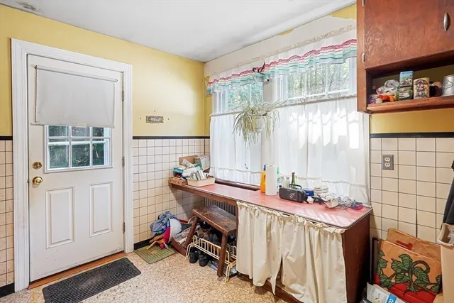 a room with a baby crib furniture and a window