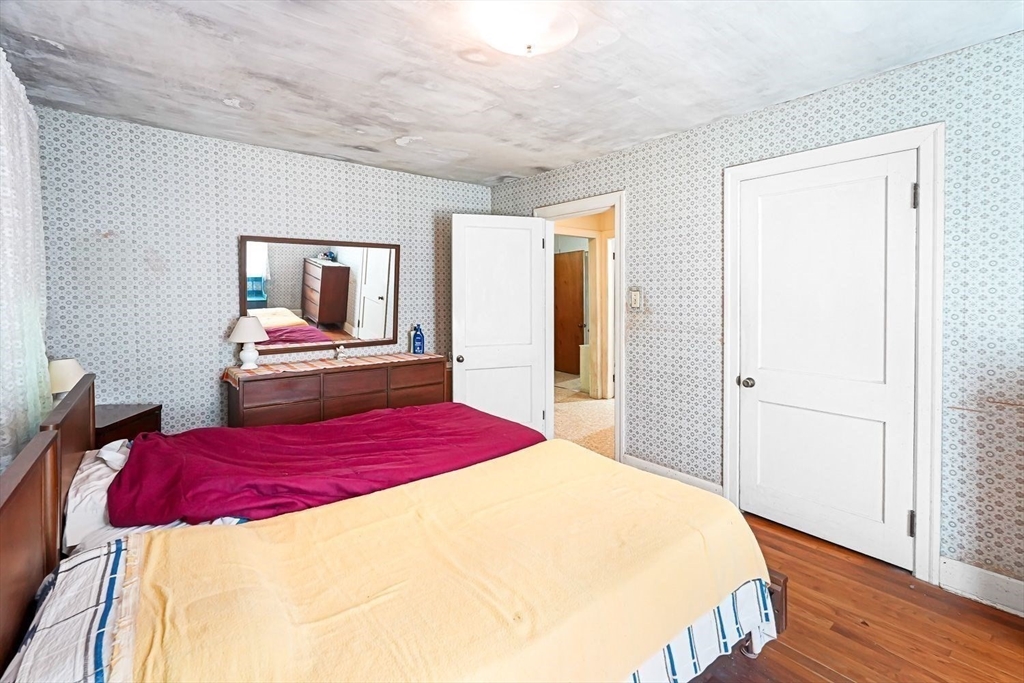 74 River Road Sturbridge, MA 01566 - Photo 22 of 40 a bedroom with a bed and wooden floor