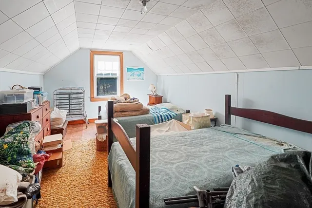 a bedroom with furniture and a large window