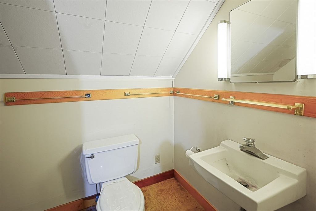 74 River Road Sturbridge, MA 01566 - Photo 31 of 40 a bathroom with a sink a toilet and a window