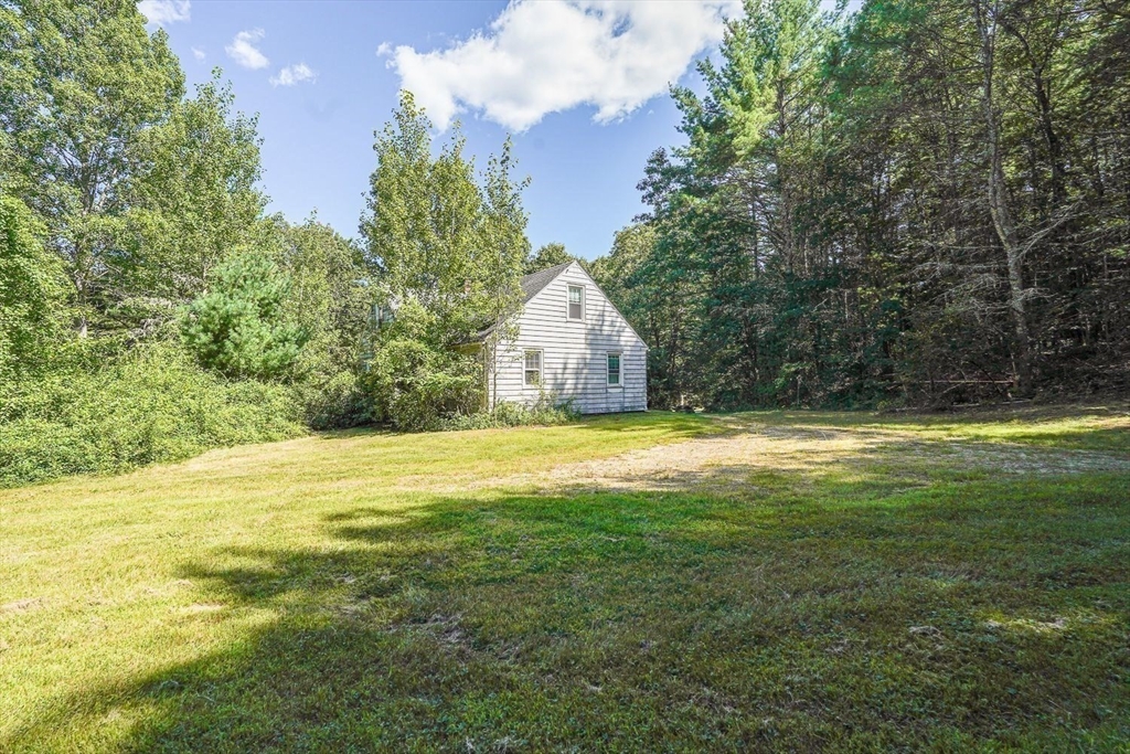 74 River Road Sturbridge, MA 01566 - Photo 5 of 40 a house with a yard in front of it