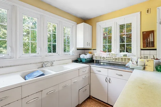 a kitchen with sink attached with living room