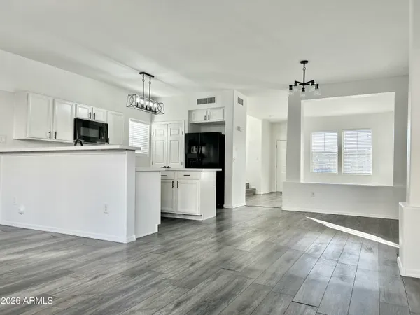 a view of a kitchen with wooden floor and a kitchen