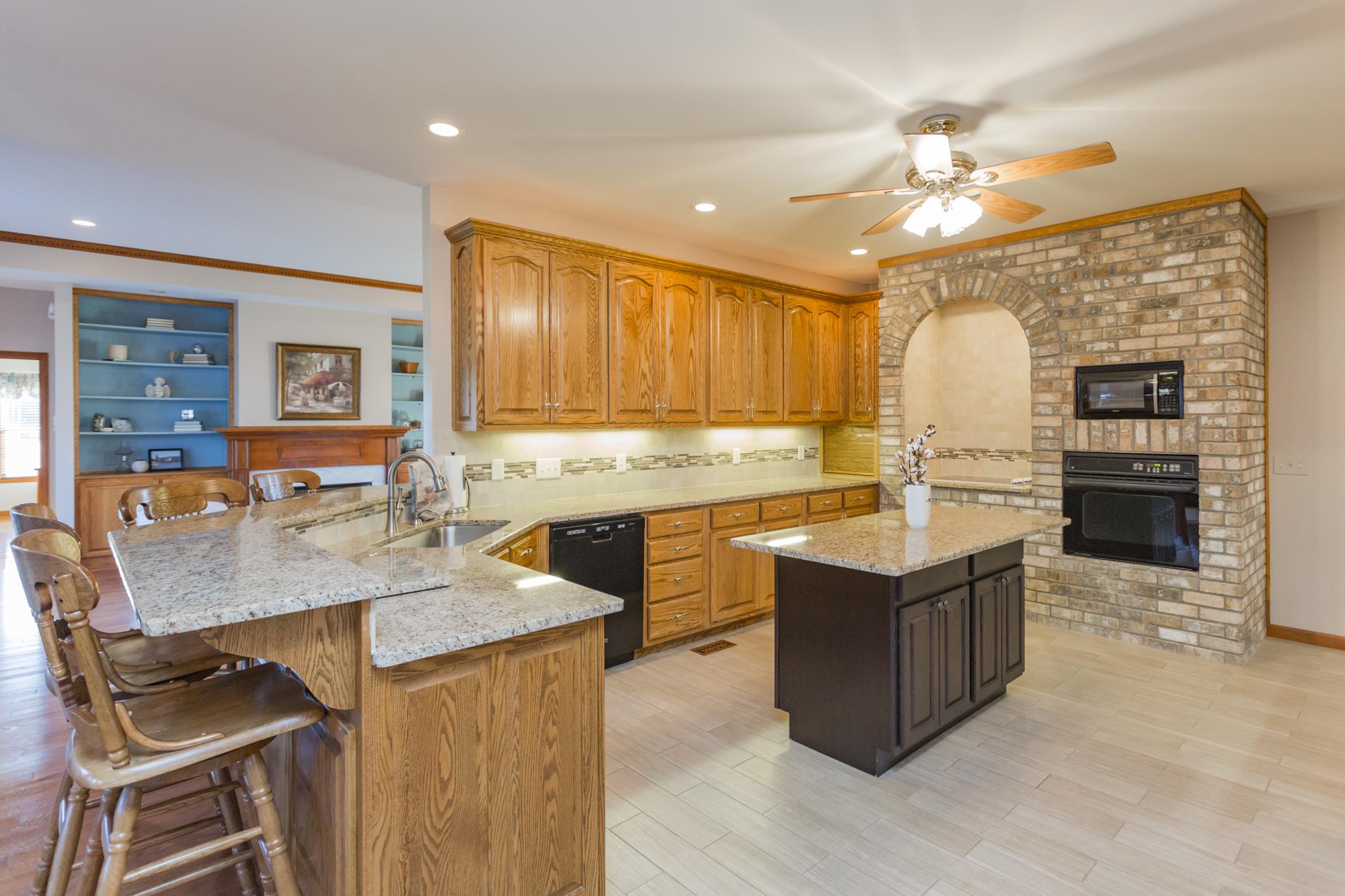 7768 Gum Puckett Road Murfreesboro, TN 37127 - Photo 7 of 27 Custom Oak Cabinetry with contrast island. Granite Counter tops, Roll Top Appliance Garage, Wall Oven and Microwave and separate cook top.