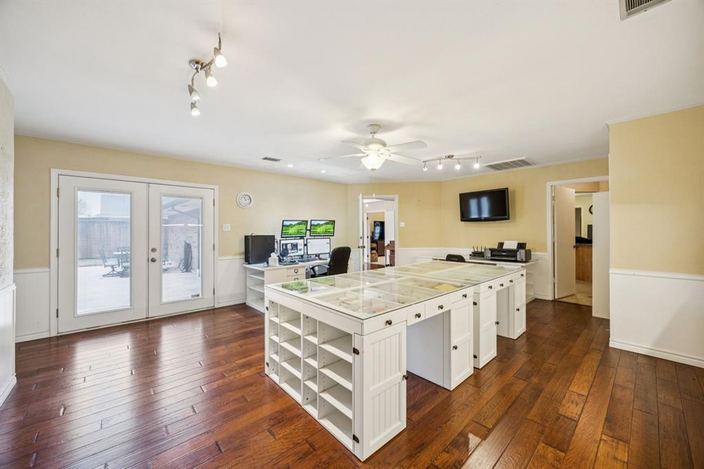 314 Amherst Avenue Richardson, TX 75081 - Photo 25 of 38 a large kitchen with stainless steel appliances granite countertop a lot of counter space and wooden floor