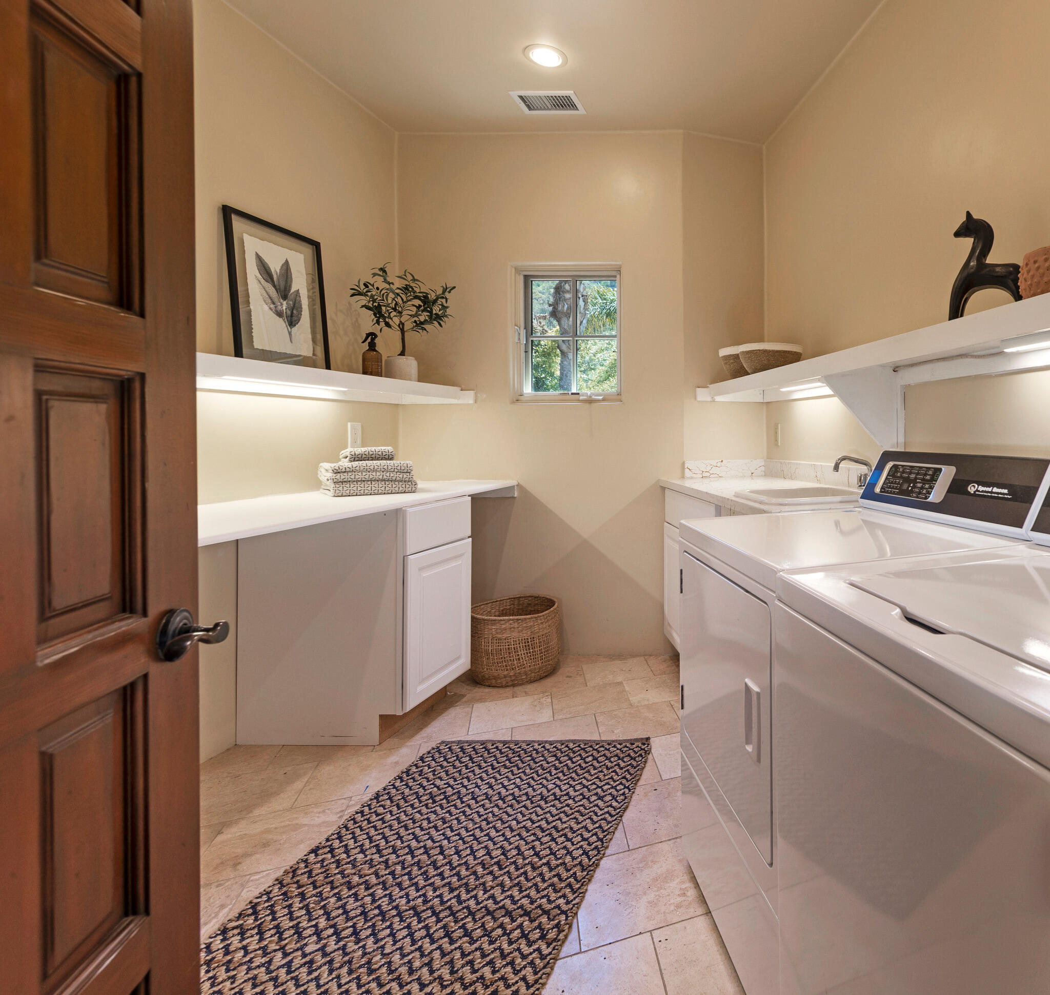 1493 Sycamore Canyon Road Montecito, CA 93108 - Photo 31 of 47 a room with a sink and cabinets