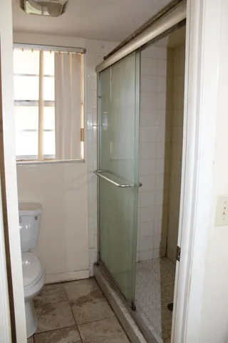 a bathroom with a glass shower door