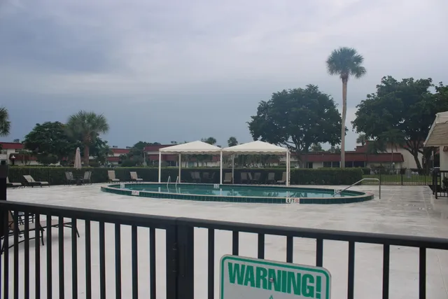 a view of a balcony with wooden floor and fence