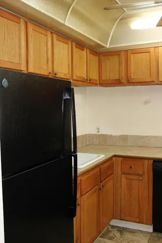 a view of a kitchen with wooden floor and cabinets