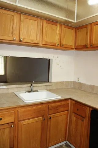 a kitchen with a sink and cabinets