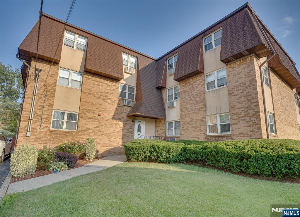 1138F Farm Road, Unit D Secaucus, NJ 07094 - Photo 1 of 8 a view of a brick house with a yard