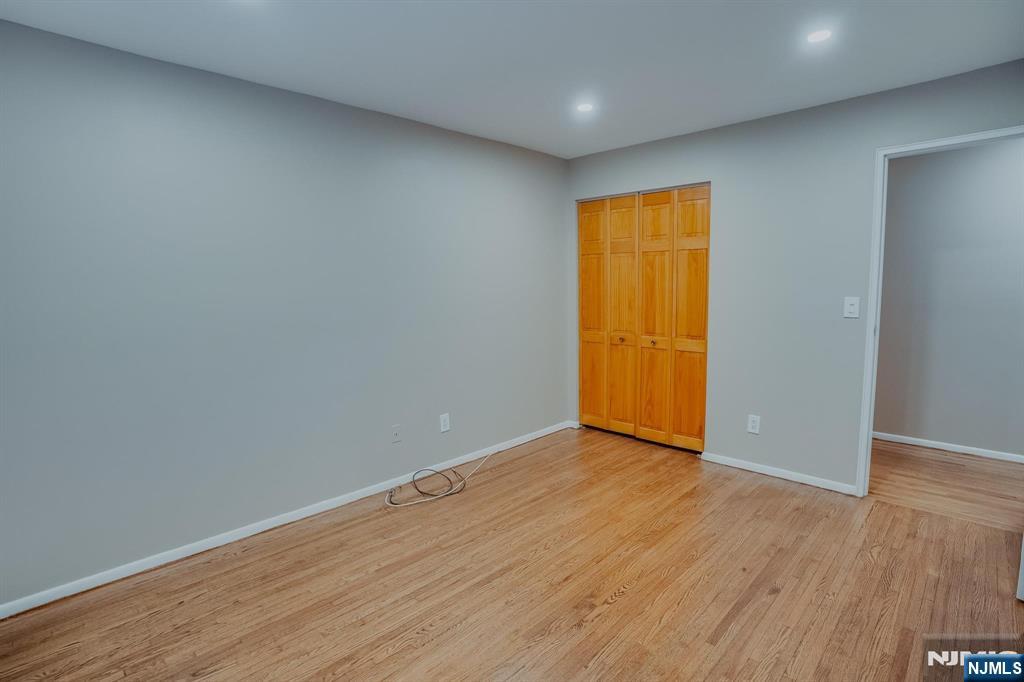 1138F Farm Road, Unit D Secaucus, NJ 07094 - Photo 7 of 8 a view of an empty room with wooden floor