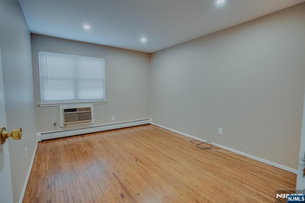 1138F Farm Road, Unit D Secaucus, NJ 07094 - Photo 8 of 8 a view of empty room with wooden floor and fan