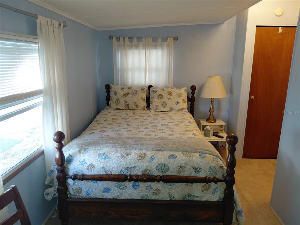 980 7th Street Northwest, Unit 1 Largo, FL 33770 - Photo 15 of 36 a bed sitting in a bedroom next to a window