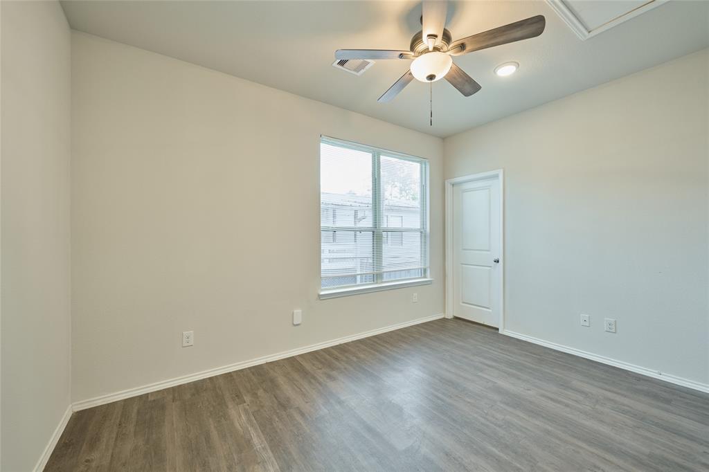 9992 Calendar Street Willis, TX 77318 - Photo 13 of 25 wooden floor in an empty room with a window