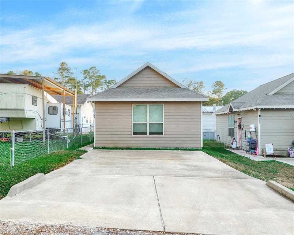 9992 Calendar Street Willis, TX 77318 - Photo 23 of 25 a front view of a house with a yard and garage