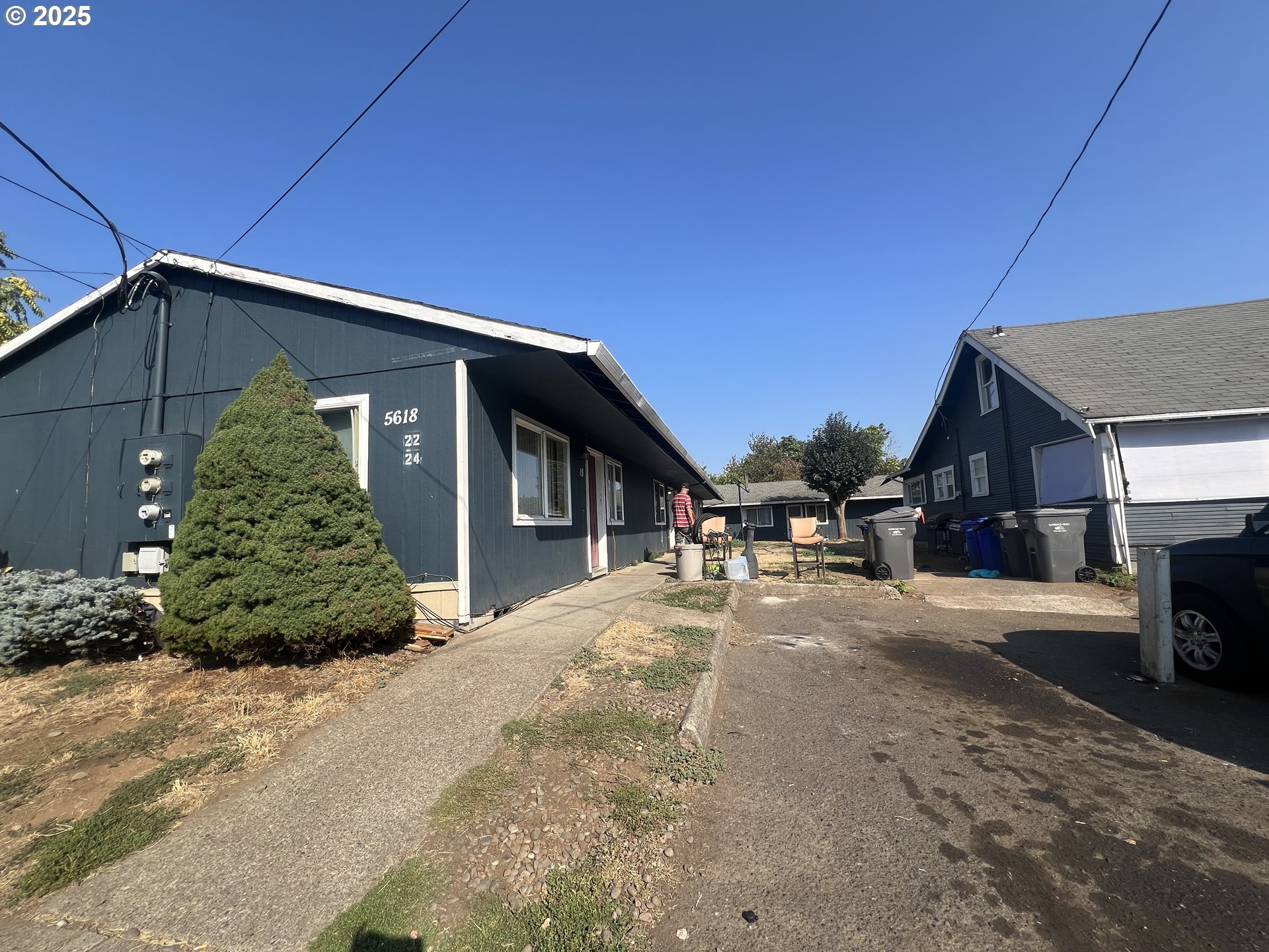 5628 Southeast 87th Avenue Portland, OR 97266 - Photo 3 of 10 a front view of a house with a yard and garage