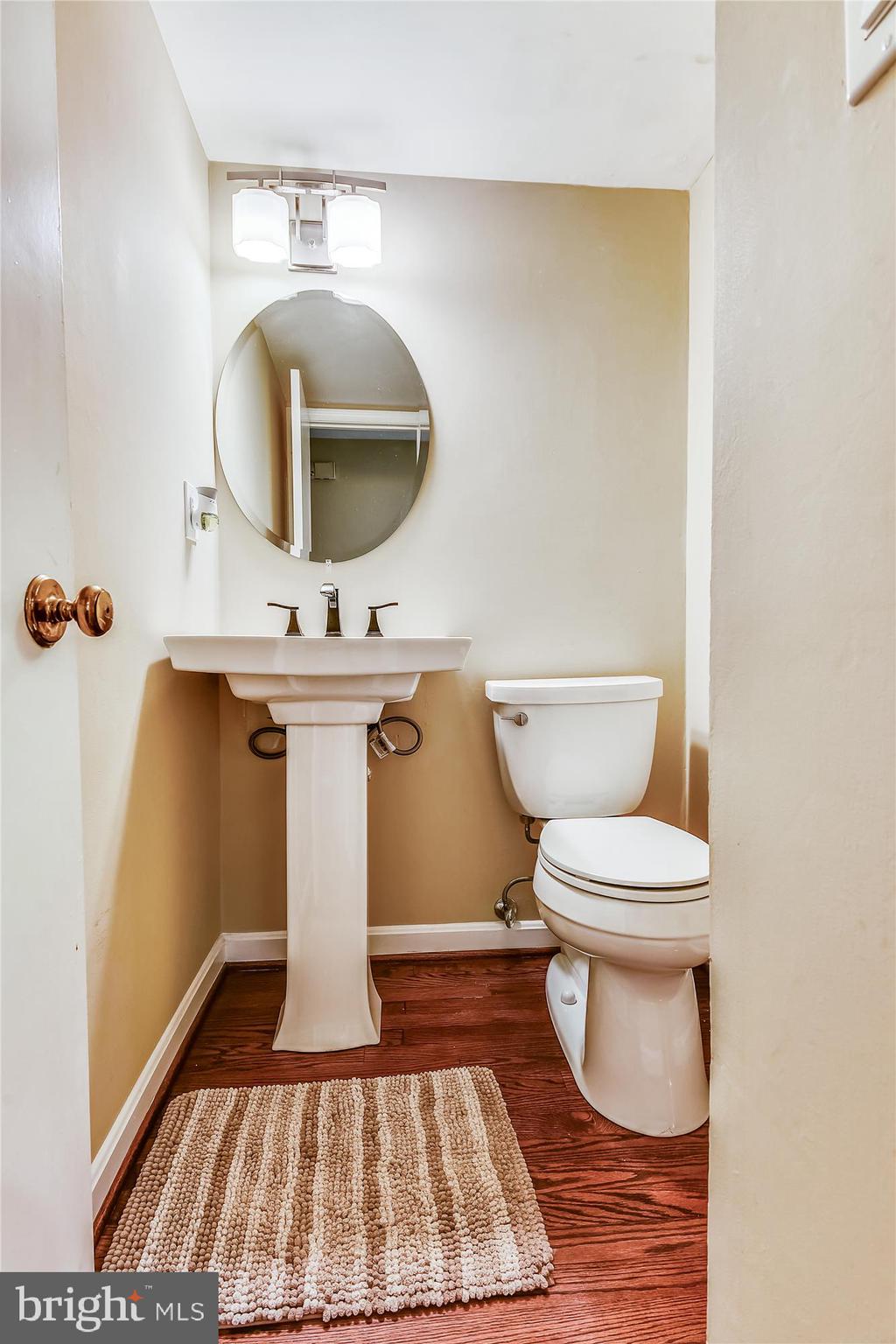 13621 Middlevale Lane Silver Spring, MD 20906 - Photo 13 of 25 a spacious bathroom with a toilet a sink and mirror