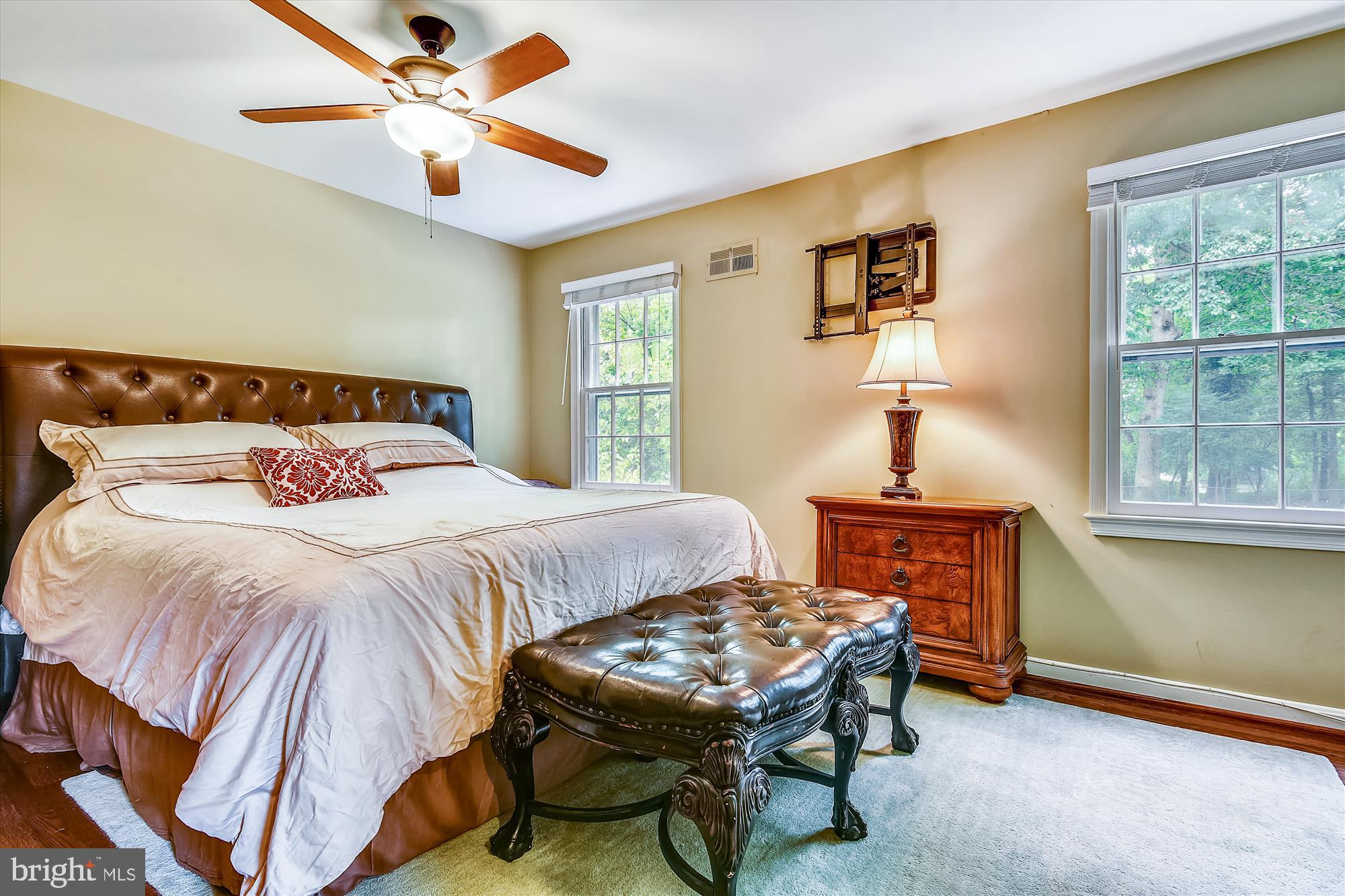 13621 Middlevale Lane Silver Spring, MD 20906 - Photo 15 of 25 a bedroom with a bed and a chandelier