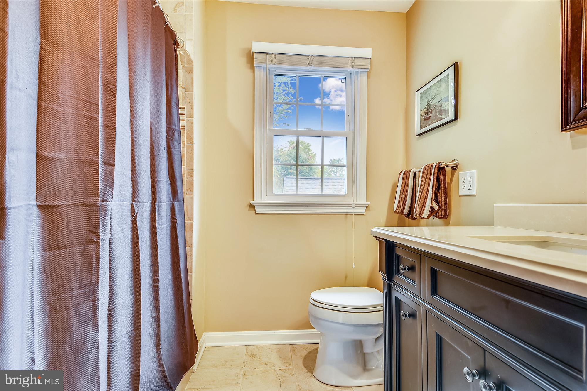13621 Middlevale Lane Silver Spring, MD 20906 - Photo 16 of 25 a bathroom with a toilet a sink and a window