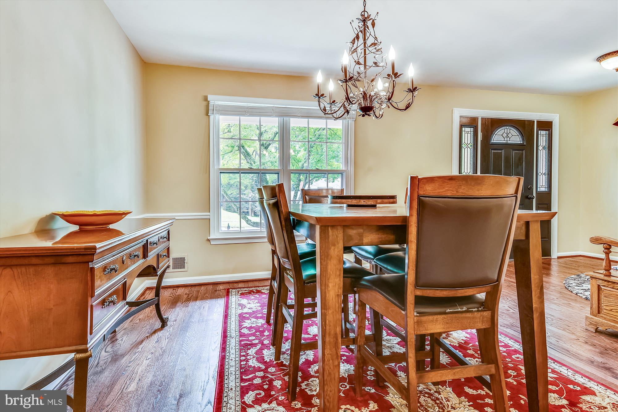 13621 Middlevale Lane Silver Spring, MD 20906 - Photo 4 of 25 a view of a dining room with furniture a chandelier and wooden floor