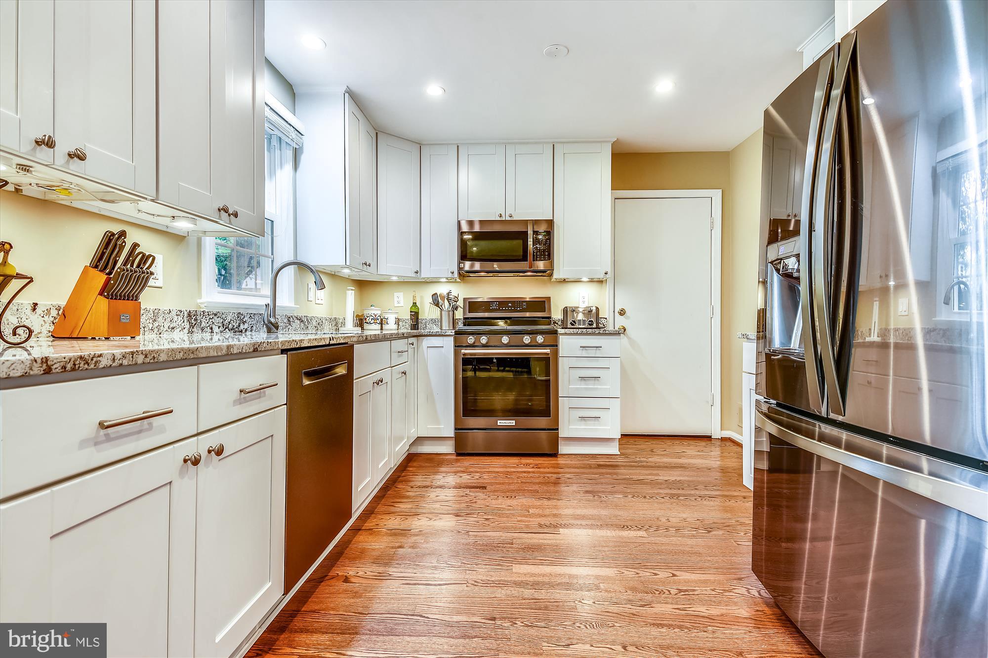 13621 Middlevale Lane Silver Spring, MD 20906 - Photo 6 of 25 a kitchen with stainless steel appliances granite countertop a refrigerator and a stove top oven