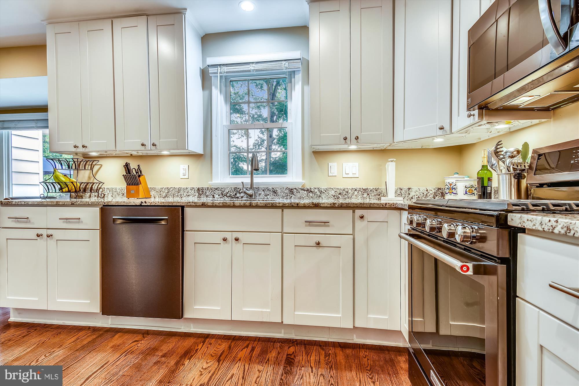 13621 Middlevale Lane Silver Spring, MD 20906 - Photo 7 of 25 a kitchen with granite countertop cabinets stainless steel appliances a sink and a window