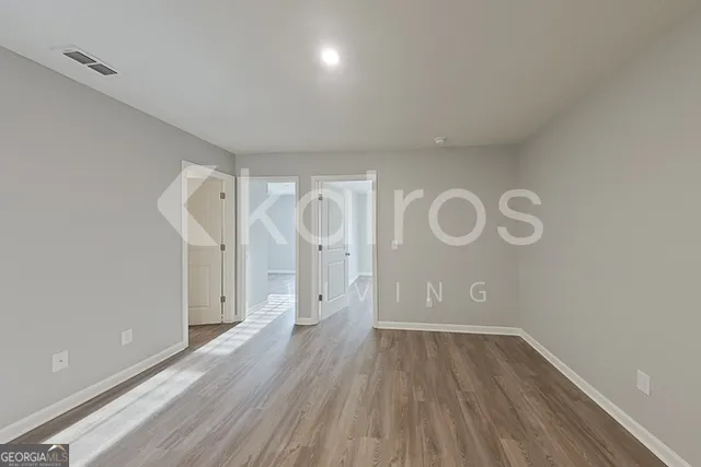 a view of room with wooden floor