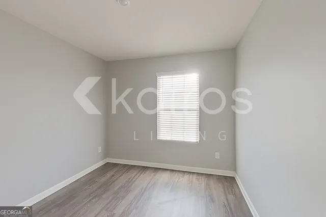a view of room with window and hardwood floor