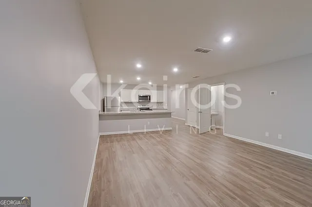 a view of kitchen and wooden floor