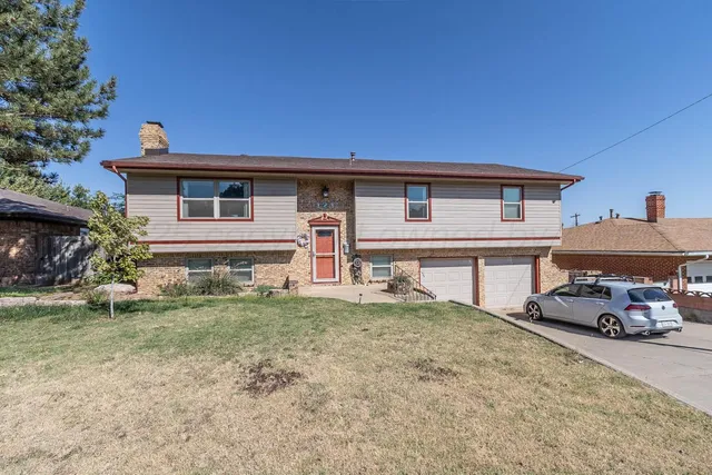 a car parked in front of white house