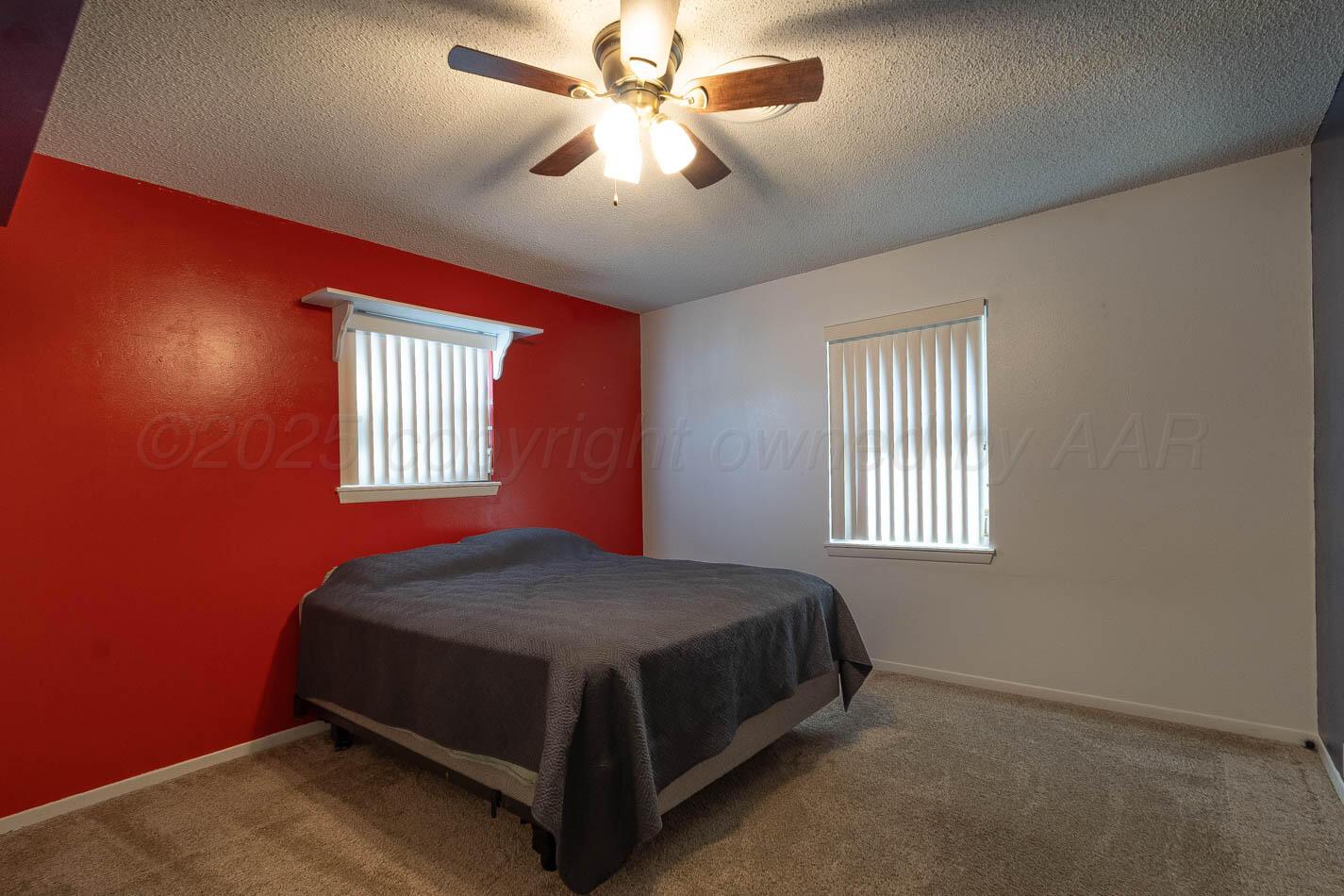 121 Houston Street Borger, TX 79007 - Photo 11 of 21 a bedroom with a bed next to a window