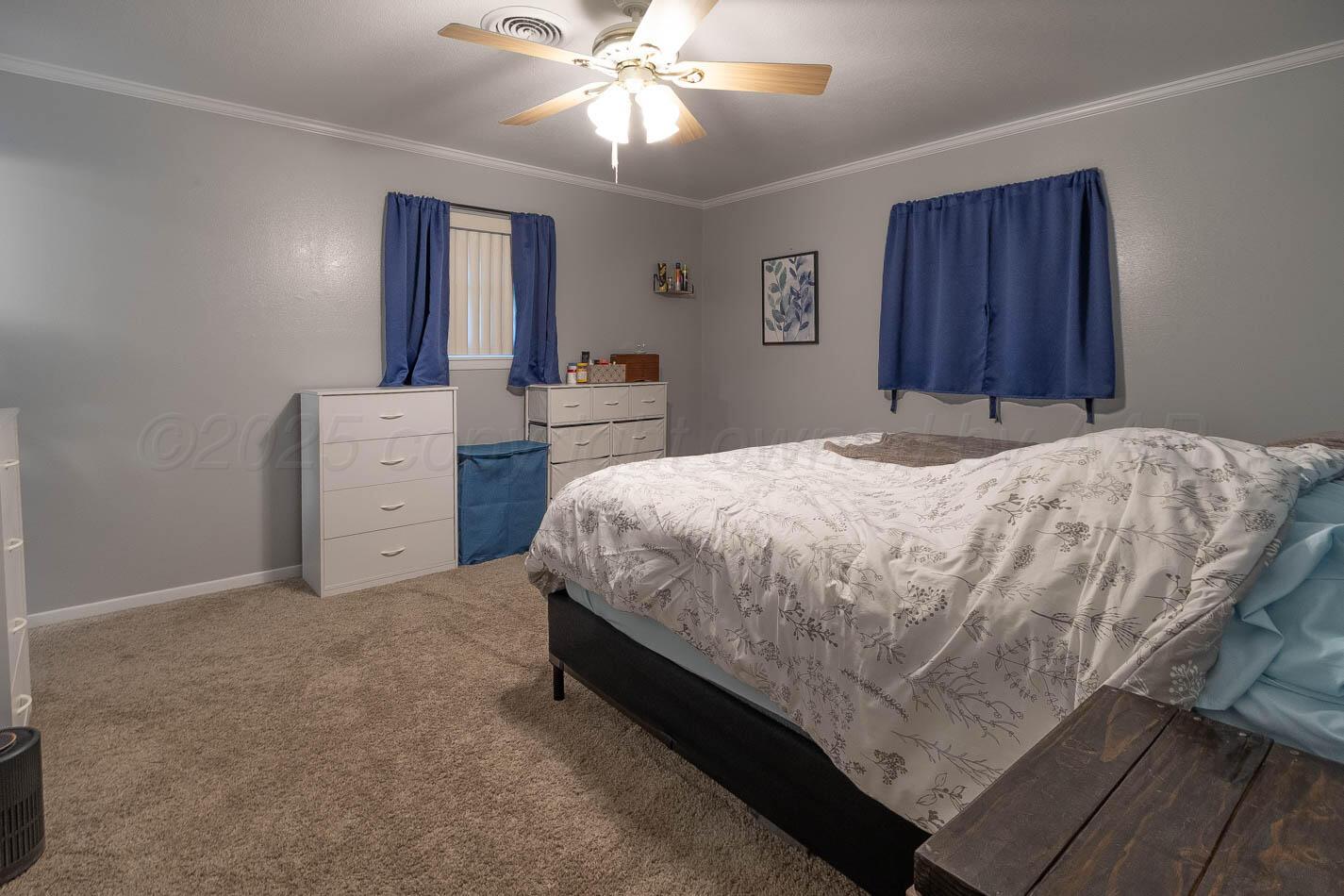 121 Houston Street Borger, TX 79007 - Photo 12 of 21 a bedroom with a bed and a chandelier