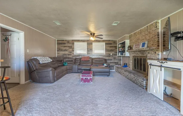 a living room with furniture and a fireplace