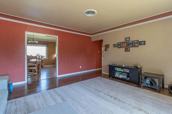 a view of a livingroom with wooden floor and a fireplace