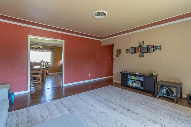 a view of a livingroom with wooden floor and a fireplace