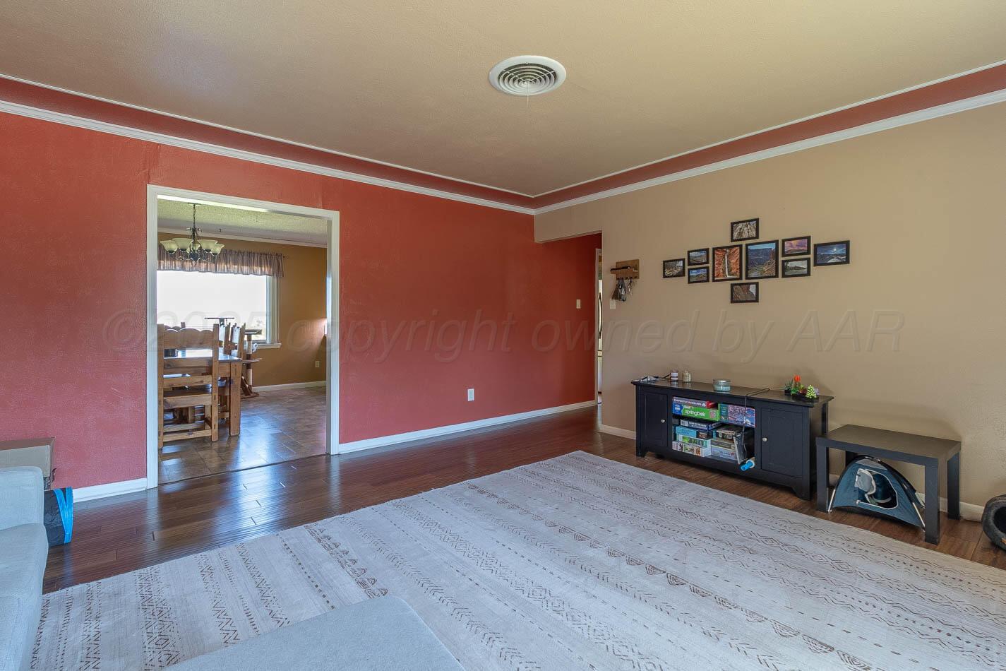 121 Houston Street Borger, TX 79007 - Photo 19 of 21 a view of a livingroom with wooden floor and a fireplace