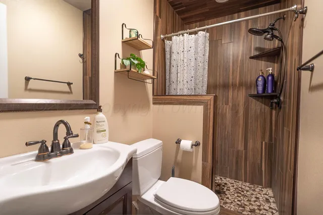 a bathroom with a sink toilet and shower