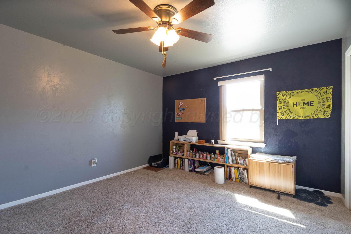 121 Houston Street Borger, TX 79007 - Photo 9 of 21 a workspace with a bookshelf