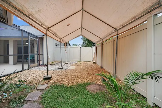 a view of a patio with a table and chairs