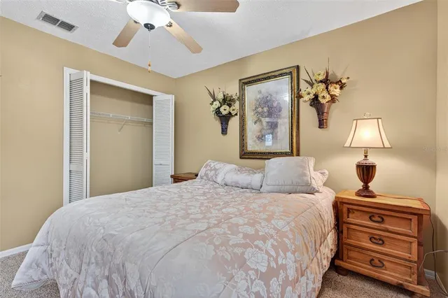 a bathroom with a granite countertop toilet sink and mirror
